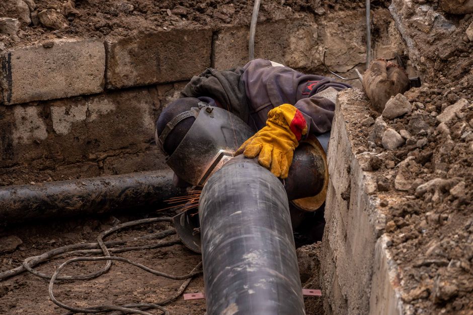 Close-up of a worker inspecting a drainage pipe in Hertfordshire