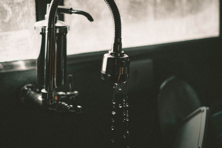 Close-up of a slow draining sink with water pooling in a typical Hertfordshire kitchen